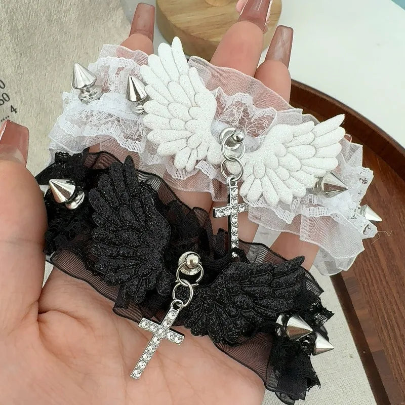 Velvet choker necklace with angel wings, lace, spikes, and cross pendant in black and white designs