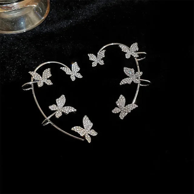 silver butterfly cuff earrings with sparkling crystals on black background